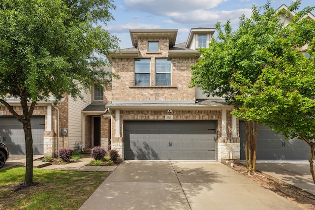 2321 Molly Ln, Plano, TX 75074 - view of front of house with driveway, stone siding, a garage, and brick siding