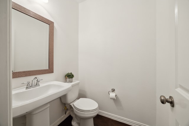 2321 Molly Ln, Plano, TX 75074 - half bathroom with baseboards, wood finished floors, and toilet