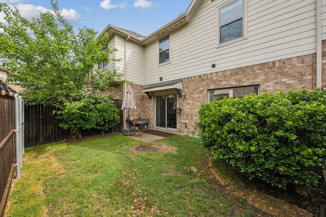 2321 Molly Ln, Plano, TX 75074 - back of house with a lawn, a fenced backyard, and brick siding