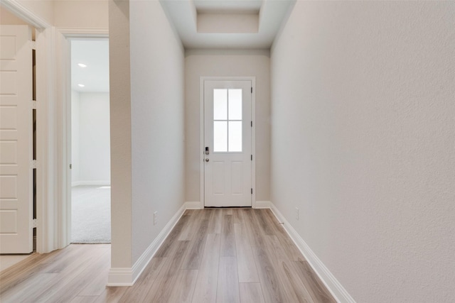 entryway with baseboards and light wood-style floors
