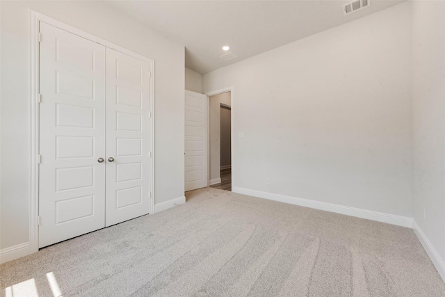 unfurnished bedroom featuring visible vents, carpet flooring, and baseboards