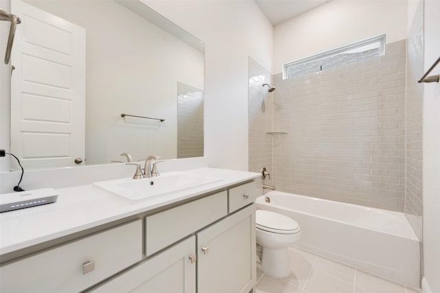 bathroom with tile patterned floors, toilet,  shower combination, and vanity
