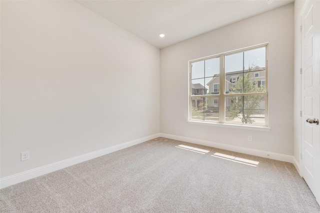 spare room featuring baseboards, recessed lighting, and carpet flooring