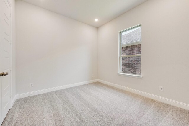 carpeted empty room featuring baseboards and recessed lighting