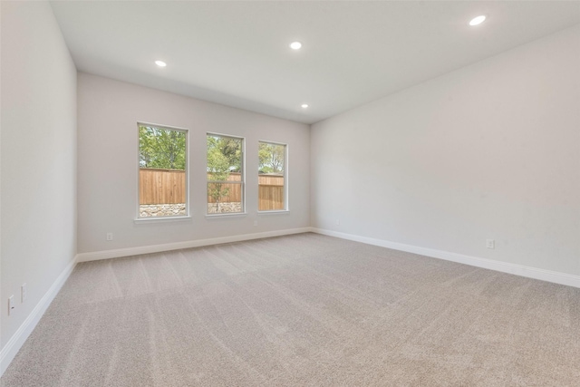 spare room with recessed lighting, carpet floors, and baseboards