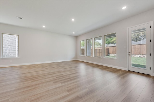 unfurnished living room featuring recessed lighting, visible vents, light wood-style flooring, and plenty of natural light