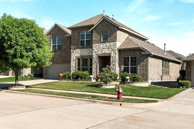 view of front facade featuring brick siding, a front lawn, driveway, and an attached garage