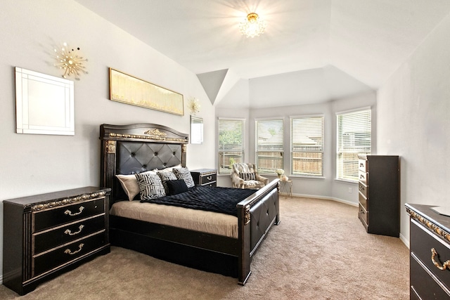 bedroom featuring light colored carpet, vaulted ceiling, and baseboards