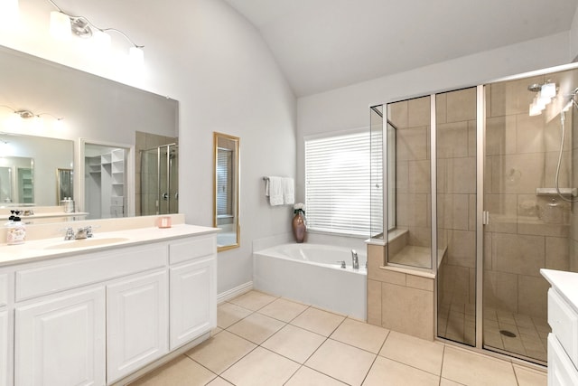 full bathroom featuring vanity, a bath, a shower stall, and tile patterned floors