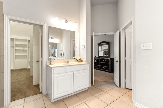 bathroom with tile patterned floors, vanity, and baseboards