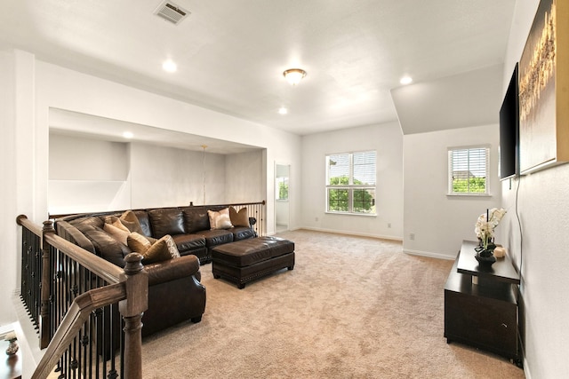 living area with baseboards, visible vents, light carpet, and recessed lighting