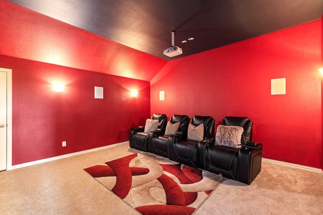 cinema featuring lofted ceiling, baseboards, and carpet floors