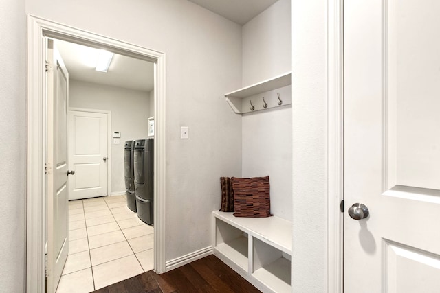 mudroom featuring washer and dryer, tile patterned flooring, and baseboards