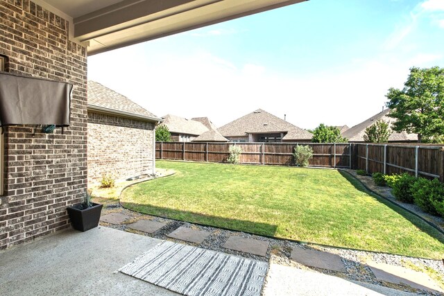 view of yard with a patio and a fenced backyard