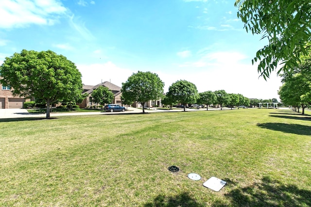 view of property's community featuring a yard