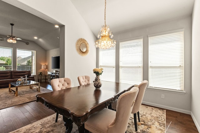 dining room featuring lofted ceiling, hardwood / wood-style floors, baseboards, and ceiling fan with notable chandelier