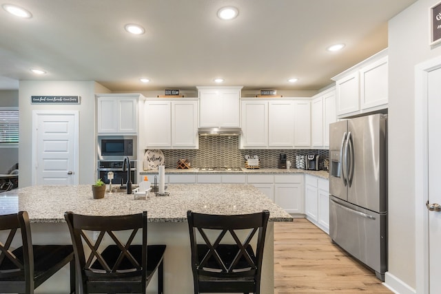 4114 Anglers Way, Royse City, TX 75189 - kitchen featuring white cabinetry, stainless steel appliances, backsplash, and light wood-style flooring