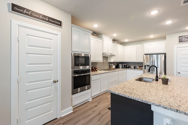 4114 Anglers Way, Royse City, TX 75189 - kitchen featuring light wood finished floors, a sink, stainless steel appliances, tasteful backsplash, and white cabinetry