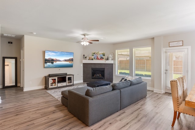 4114 Anglers Way, Royse City, TX 75189 - living area featuring a healthy amount of sunlight, a ceiling fan, a fireplace, and light wood-style flooring