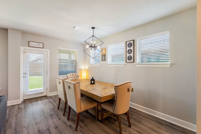 4114 Anglers Way, Royse City, TX 75189 - dining area featuring dark wood-type flooring, a chandelier, visible vents, and baseboards