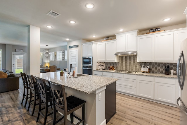 4114 Anglers Way, Royse City, TX 75189 - kitchen featuring a sink, under cabinet range hood, visible vents, white cabinetry, and appliances with stainless steel finishes