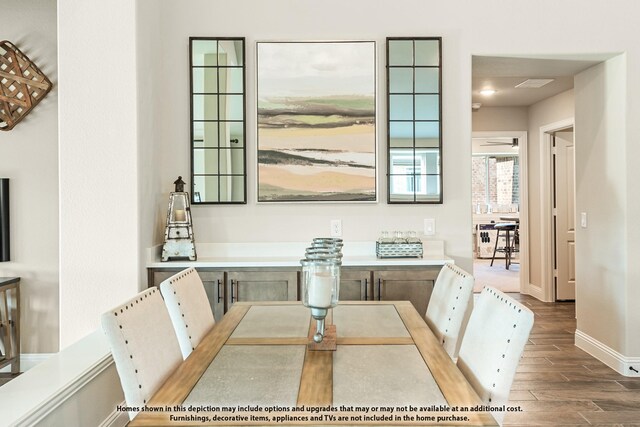 dining room with baseboards and dark wood-type flooring