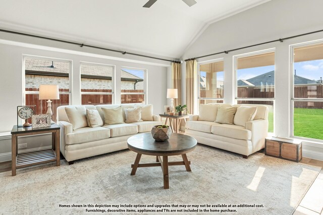 living area with ceiling fan, plenty of natural light, and vaulted ceiling