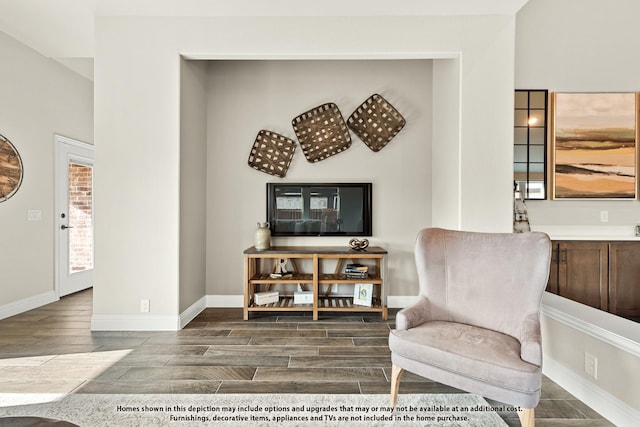 living area featuring wood finish floors and baseboards