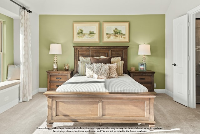 bedroom featuring light colored carpet and baseboards