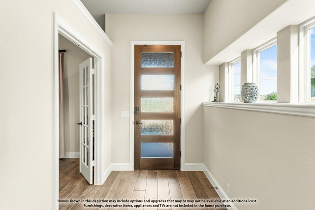 foyer featuring wood finished floors and baseboards