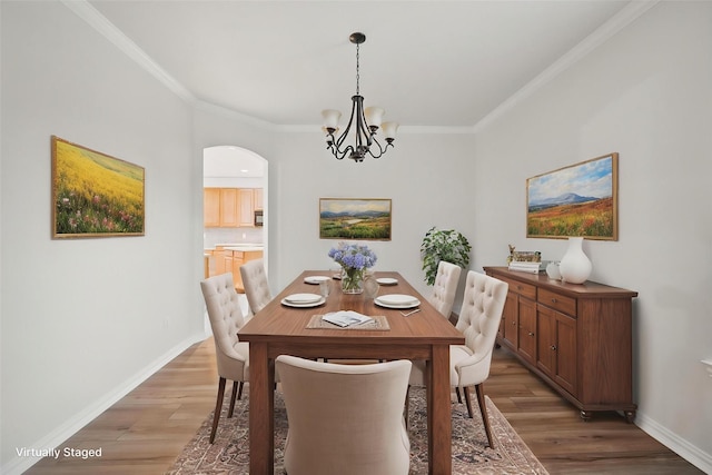 1405 Blue Gill Ln, Crowley, TX 76036 - unfurnished dining area with visible vents, crown molding, wood finished floors, arched walkways, and a notable chandelier