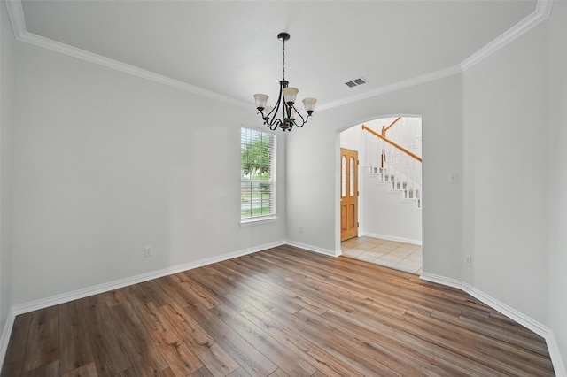 1405 Blue Gill Ln, Crowley, TX 76036 - unfurnished dining area with visible vents, arched walkways, wood finished floors, and ornamental molding