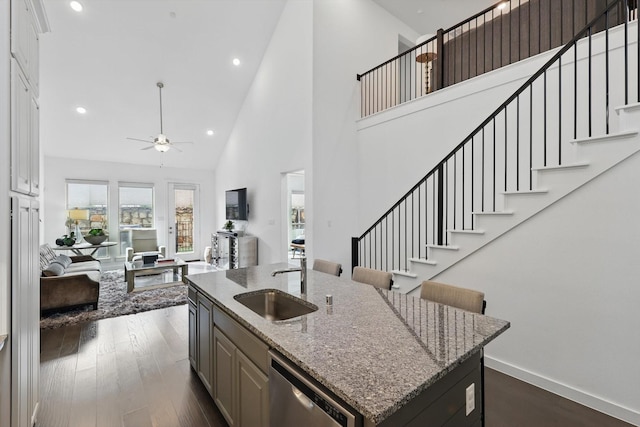 kitchen featuring a sink, high vaulted ceiling, a ceiling fan, dishwasher, and open floor plan