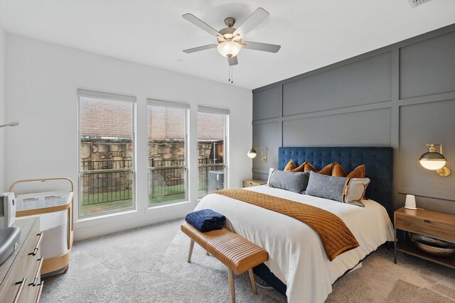 bedroom featuring ceiling fan, light colored carpet, and visible vents