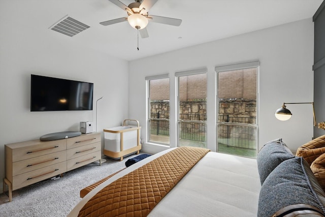 bedroom with visible vents, ceiling fan, and carpet flooring