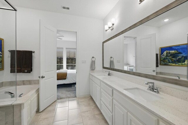 bathroom featuring a bath, a sink, tile patterned floors, and visible vents