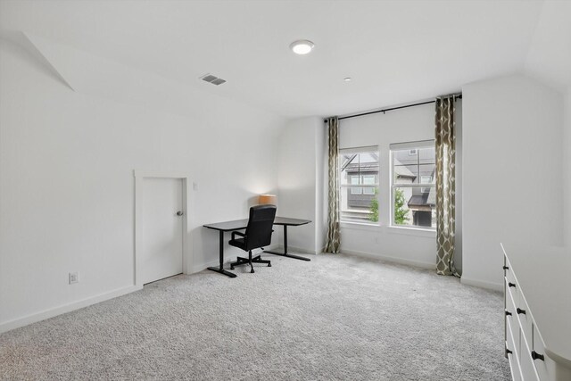 carpeted office with visible vents, lofted ceiling, and baseboards