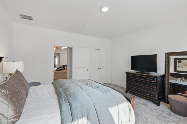 bedroom featuring visible vents and light colored carpet