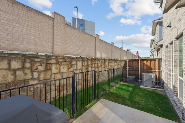 view of yard with a fenced backyard and cooling unit