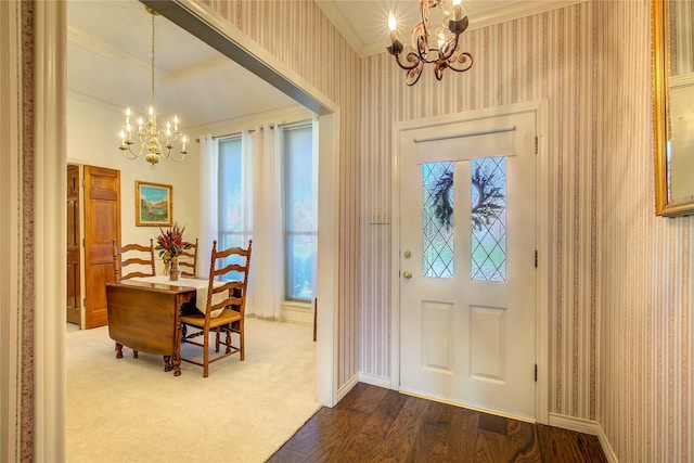 foyer entrance with an inviting chandelier, wallpapered walls, and a healthy amount of sunlight