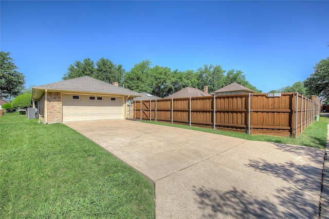 exterior space with central air condition unit, a yard, a detached garage, brick siding, and fence