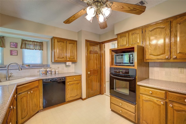 kitchen with black appliances, backsplash, brown cabinets, and a sink