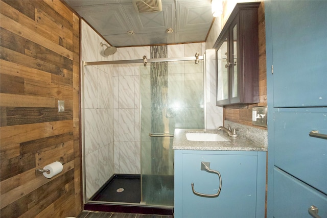 216 S Mesquite St, Muenster, TX 76252 - full bathroom featuring vanity, an ornate ceiling, a shower stall, and wood walls