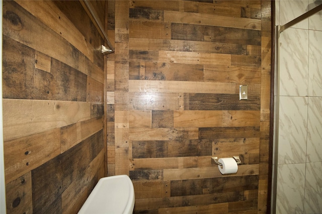 216 S Mesquite St, Muenster, TX 76252 - bathroom with wood walls and toilet