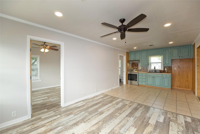216 S Mesquite St, Muenster, TX 76252 - unfurnished living room featuring light wood-style floors, a sink, ceiling fan, and ornamental molding