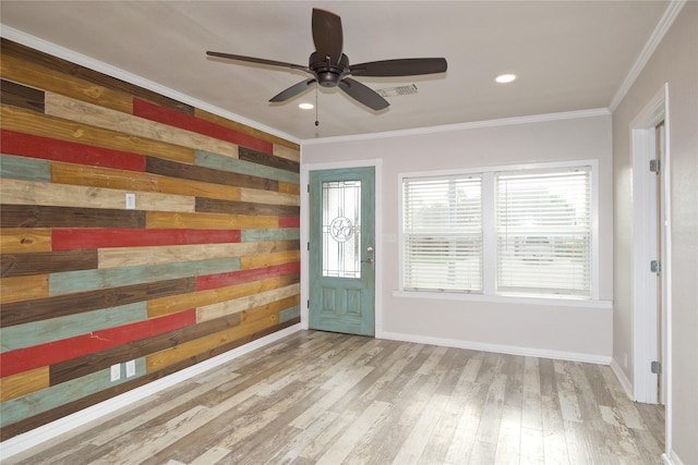 216 S Mesquite St, Muenster, TX 76252 - foyer featuring wood walls, a ceiling fan, wood finished floors, visible vents, and ornamental molding