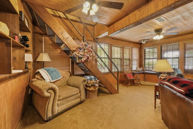 interior space featuring wood ceiling, wooden walls, ceiling fan, and visible vents