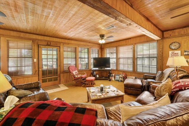 living area featuring wooden ceiling, ceiling fan, carpet flooring, and wooden walls
