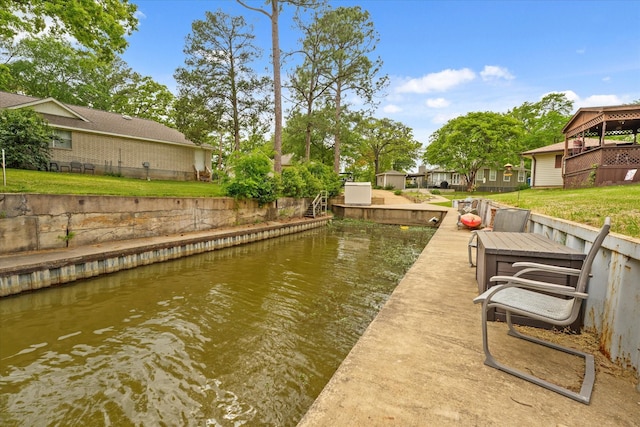dock area featuring a lawn and a water view
