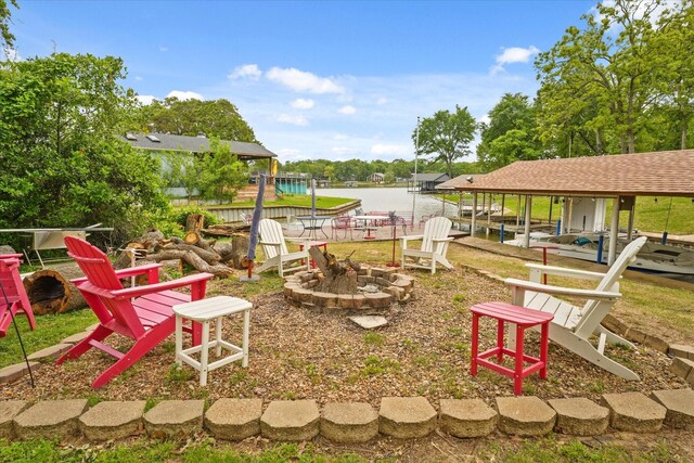 exterior space with a fire pit and a water view